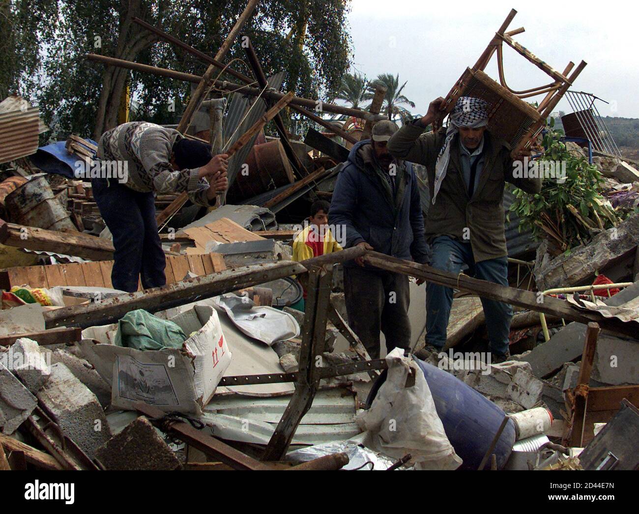 Palestinians Remove The Remains Of Their House After It Was Destroyed Along With Five Others By An Israeli Bulldozer Near The Jewish Settlement Of Netzareem In Southern Gaza Strip February 4 2001<script async src=