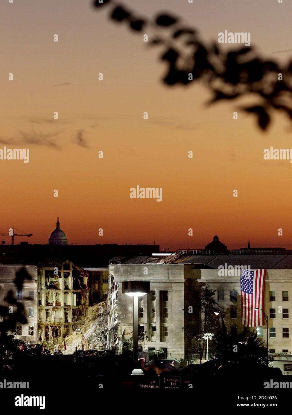 The damaged area of the Pentagon Building where a commercial jetliner slammed into it September 11, is seen in the early morning at sunrise with the U.S. Capitol Building in the background, September 17, 2001. The U.S. military said on September 15 that it would cost 'hundreds of millions' of dollars to repair the damage after a hijacked jetliner struck its 48-year-old Pentagon headquarters.REUTERS/Larry Downing  LSD/SV Stock Photo