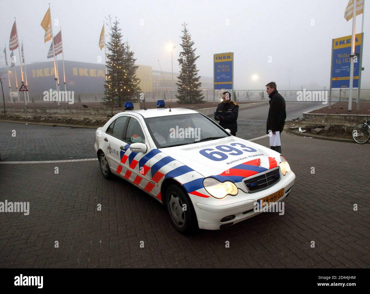 Police guard the entrance to an Ikea store in Barendrecht, near Rotterdam December 4, 2002. Police were searching 10 IKEA home furnishing stores in the Netherlands for bombs on Wednesday after explosive devices were found at branches of the world's biggest furniture retailer. All IKEA's Dutch stores were closed and its 4,000 employees told to stay home after bombs were found and defused at its stores in Amsterdam and Sliedrecht in the southwest of the country on Tuesday, police and a company spokeswoman said. REUTERS/ Guido Benschop  GDB/JDP Stock Photo