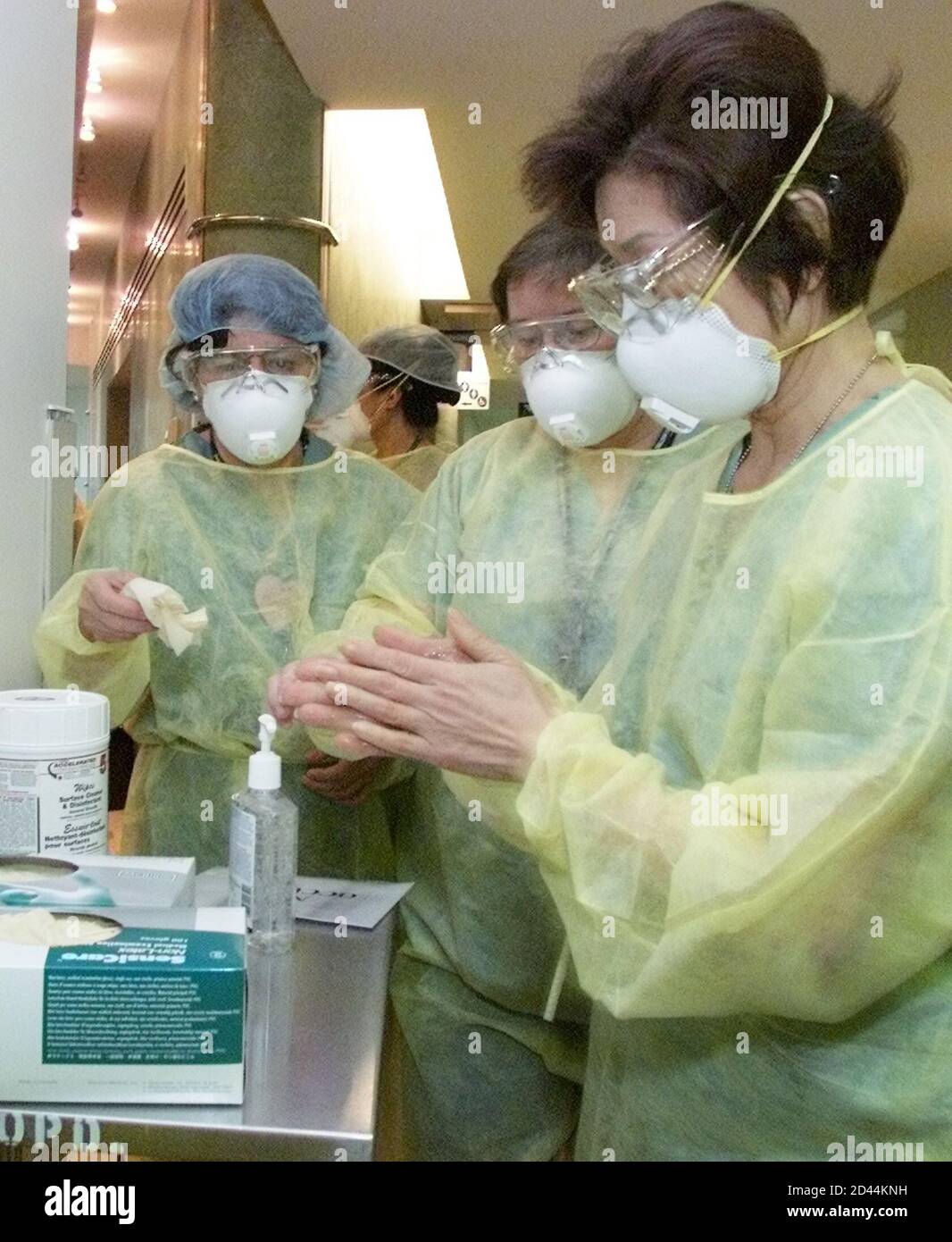 Nurses In Full Protective Clothing Wash Their Hands With Anti Bacterial Lotion Prior To Opening The Fourth Severe Acute Respriory Syndrome Sars Assessment Clinic In Ontario At The Trillium Hospital In The West