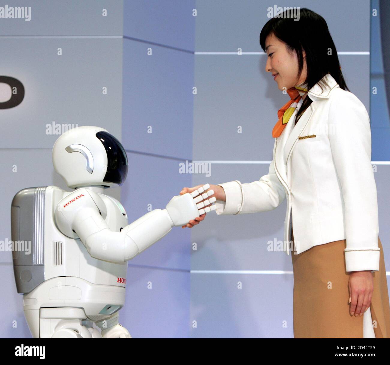 Honda Motor S Humanoid Robot Next Generation Asimo Shakes Hands With A Model At Honda S Office In Wako North Of Tokyo December 15 04 Honda Motor Corp Announced The Development Of New Technologies For The