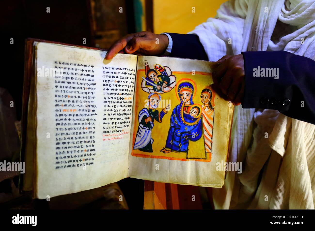 A priest displays religious texts written in ancient Geezz and Amharic,  held in the archive on the grounds of the Great Tempte pf the Moon in the  rura Stock Photo - Alamy