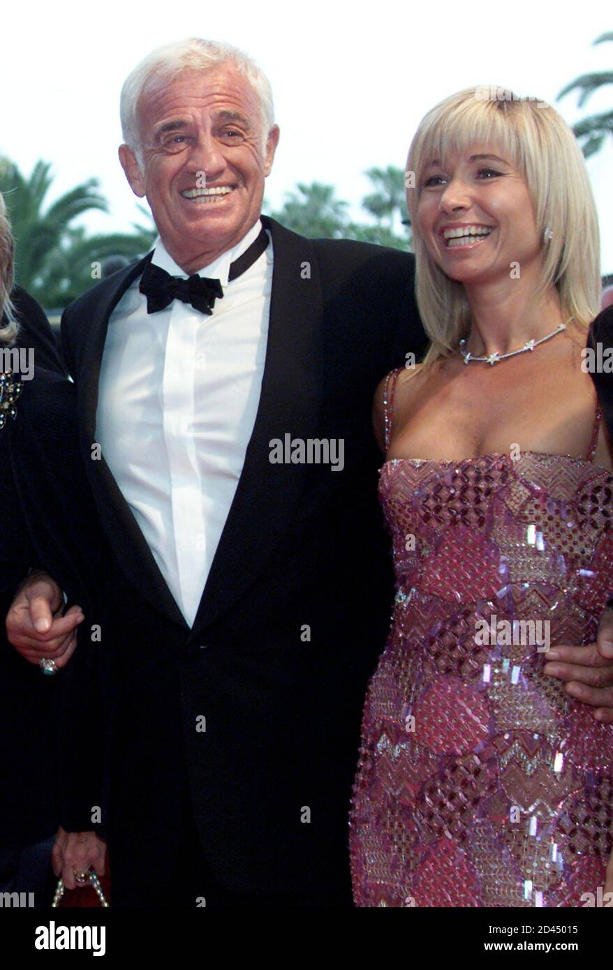 French actor Jean-Paul Belmondo (R) escorts his companion Natti as they  arrive at the festival palace ahead of an evening homage to French director  Gerard Oury by actors who starred in his