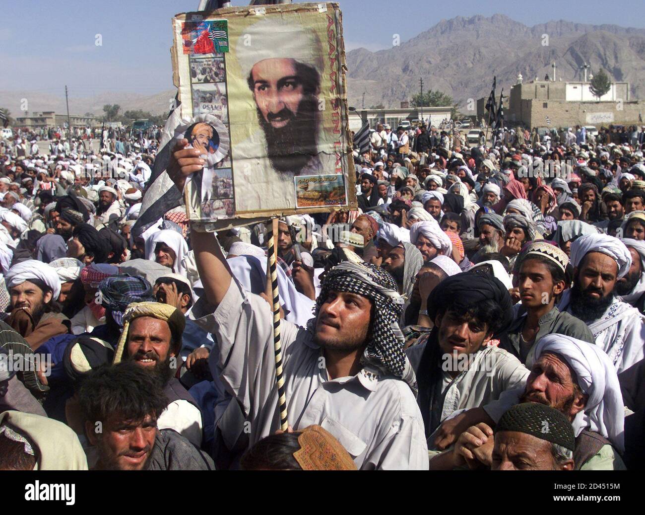 A Pakistani holds up a poster of Osama Bin Laden during a pro Taliban rally  of the biggest Islamic party, Jamt Ulma Islami (JUI) in Quetta October 2,  2001. Thousands of Taliban
