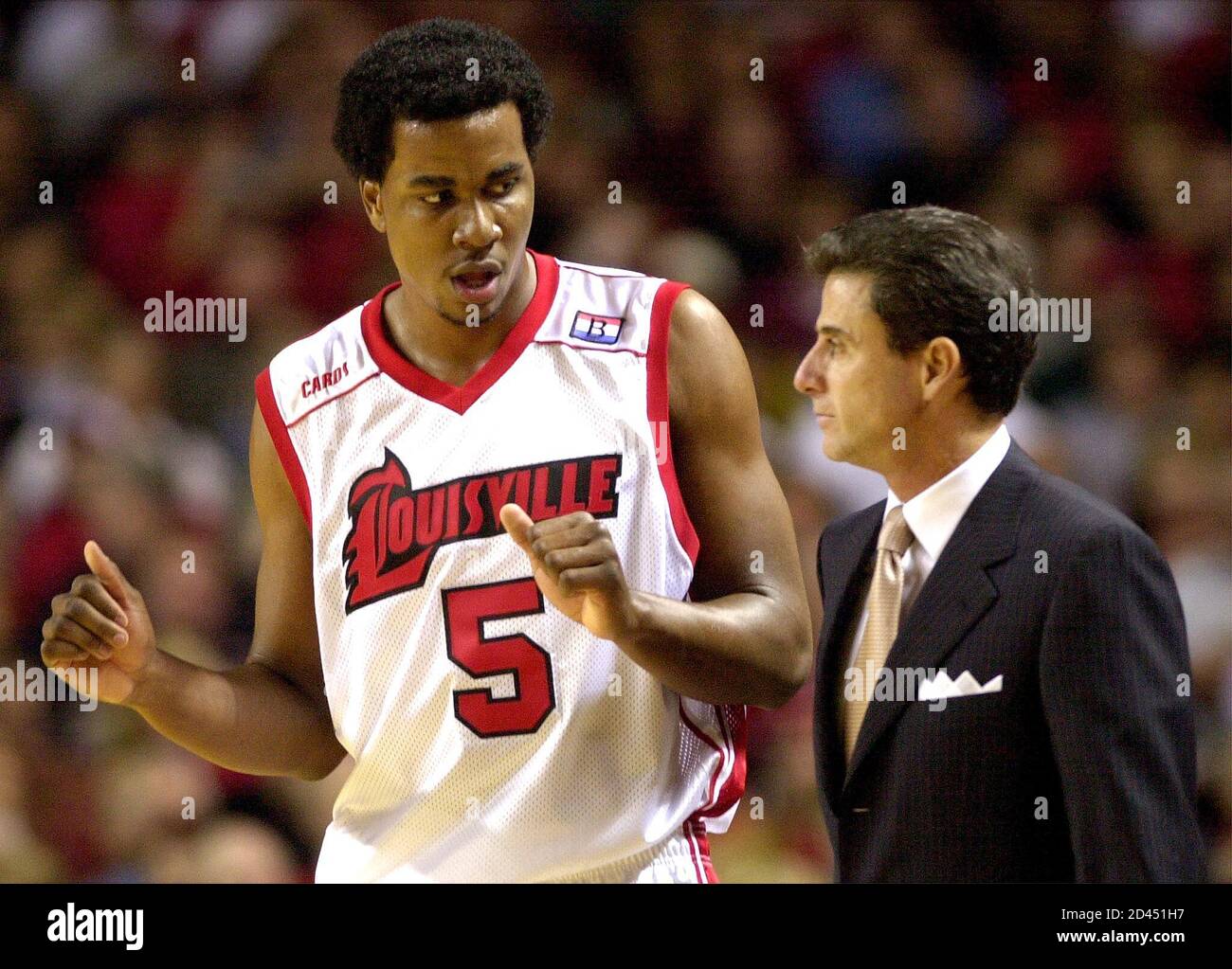 University of Louisville head basketball coach Rick Pitino (R) gives  instructions to player Brandon Bender (L) during the first half of play in  their game with the South Alabama Jaguars' at Freedom