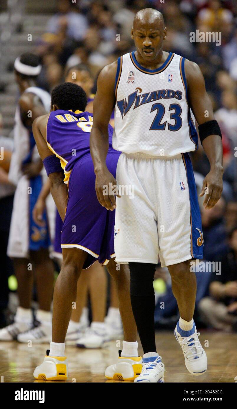 Washington Wizards Michael Jordan (23) walks past Los Angeles Lakers kobe  Bryant during second quarter action in their NBA game in Washington April  2, 2002. Jordan played only 12 minutes, a career