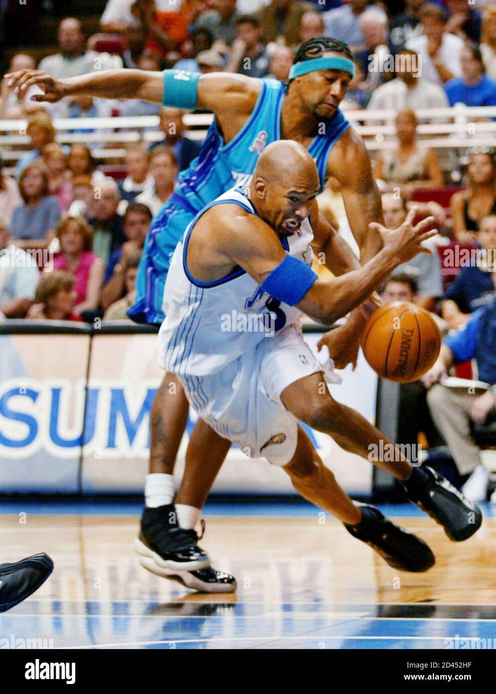 Orlando Magic forward Monte Williams has the ball knocked loose by  Charlotte Hornets' Lee Nailon during their NBA first round playoff game  played in Orlando, April 27, 2002. The teams met in