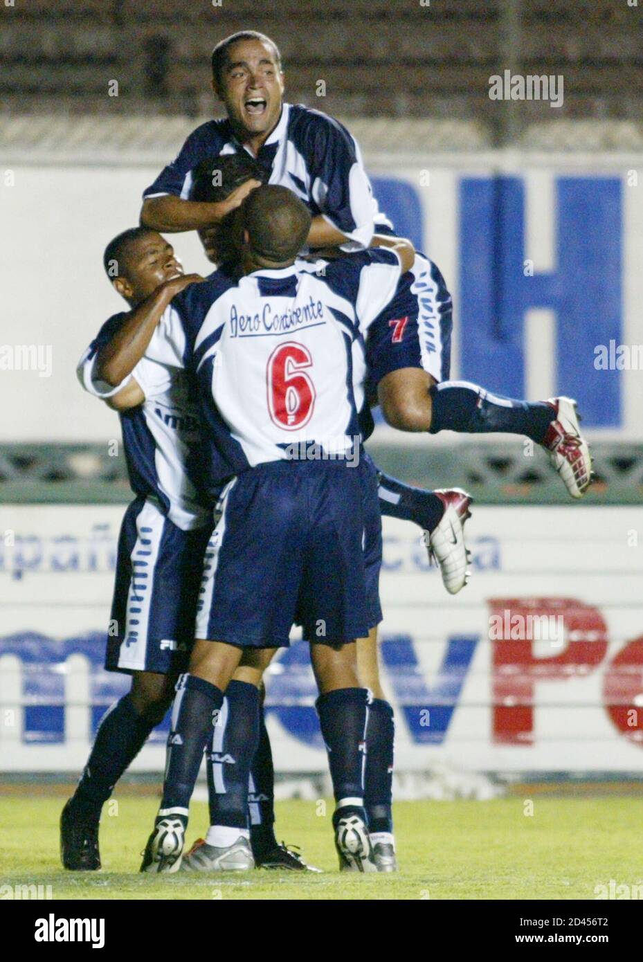 Marko Ciurlizza (top), and Junior Viza (back) from Alianza Lima celebrate  with teammates their first goal against Sporting Cristal, during the final  of the Peru's soccer championship at National stadium in Lima,