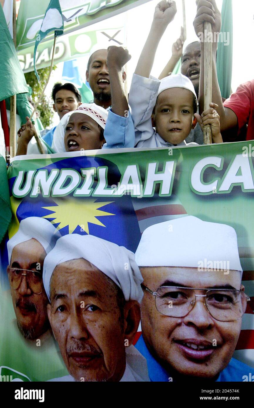 Young Supporters Of Parti Islam Semalaysia Pas Show A Poster Of Their Leader Outside The Nomination Centre In Malaysia S Northern State Of Penang March 13 2004 Malaysia Will Hold A General Election