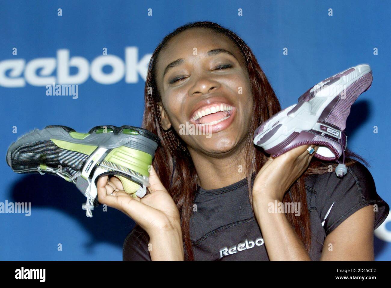 Tennis star Venus Williams holds up her signature Venus Williams Reebok  tennis shoes at a news conference in New York, December 21, 2000, after  signing a multi-million dollar endorsement contract with Reebok