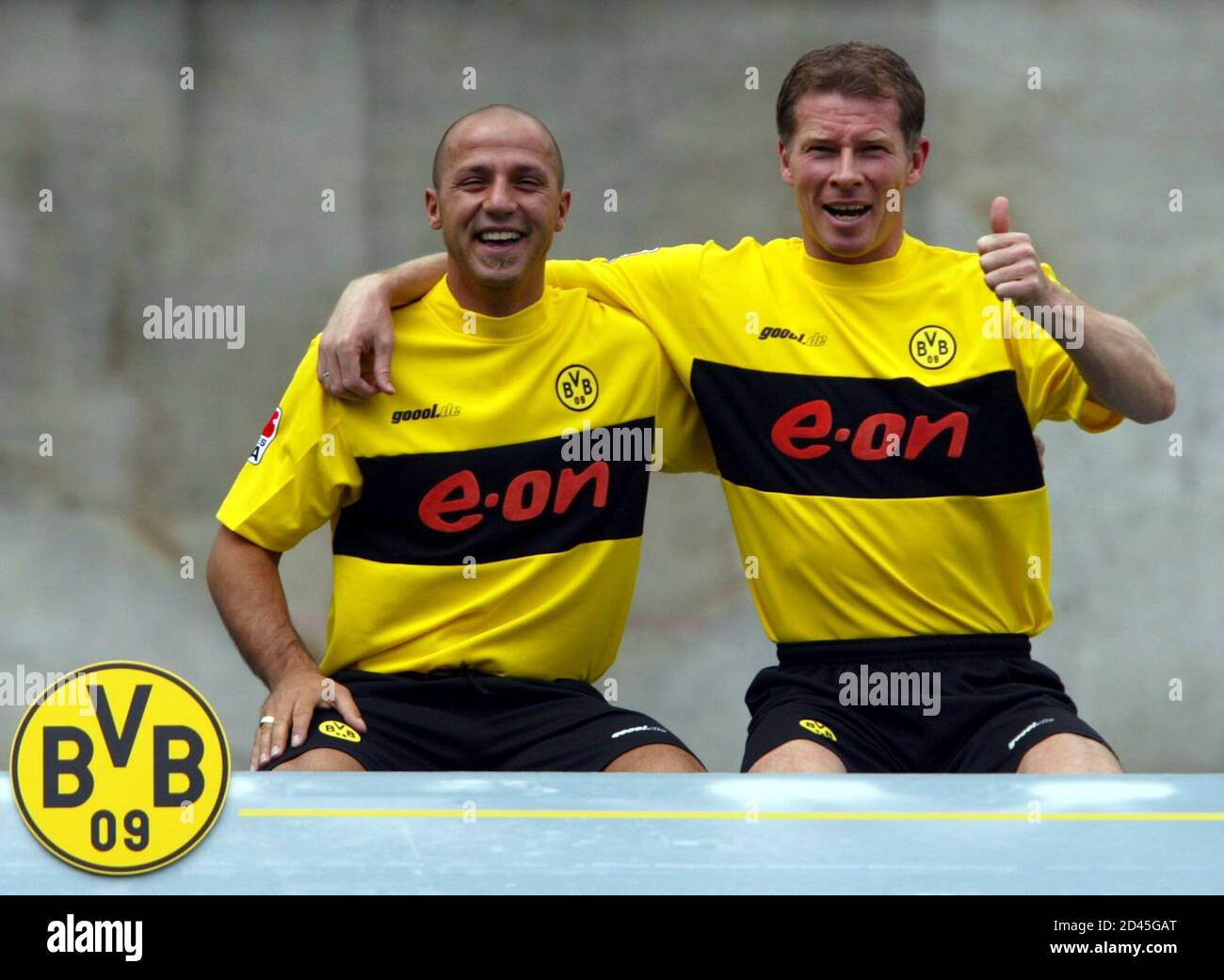 Borussia Dortmund's Giuseppe Reina (L) and Stefan Reuter (R) joke as they pose for photographers during the official team presentation in Dortmund July 5, 2002. Borussia Dortmund, which play in the German premier league won the German Championship in May 2002. REUTERS/Ina Fassbender  INA/FAB Stock Photo
