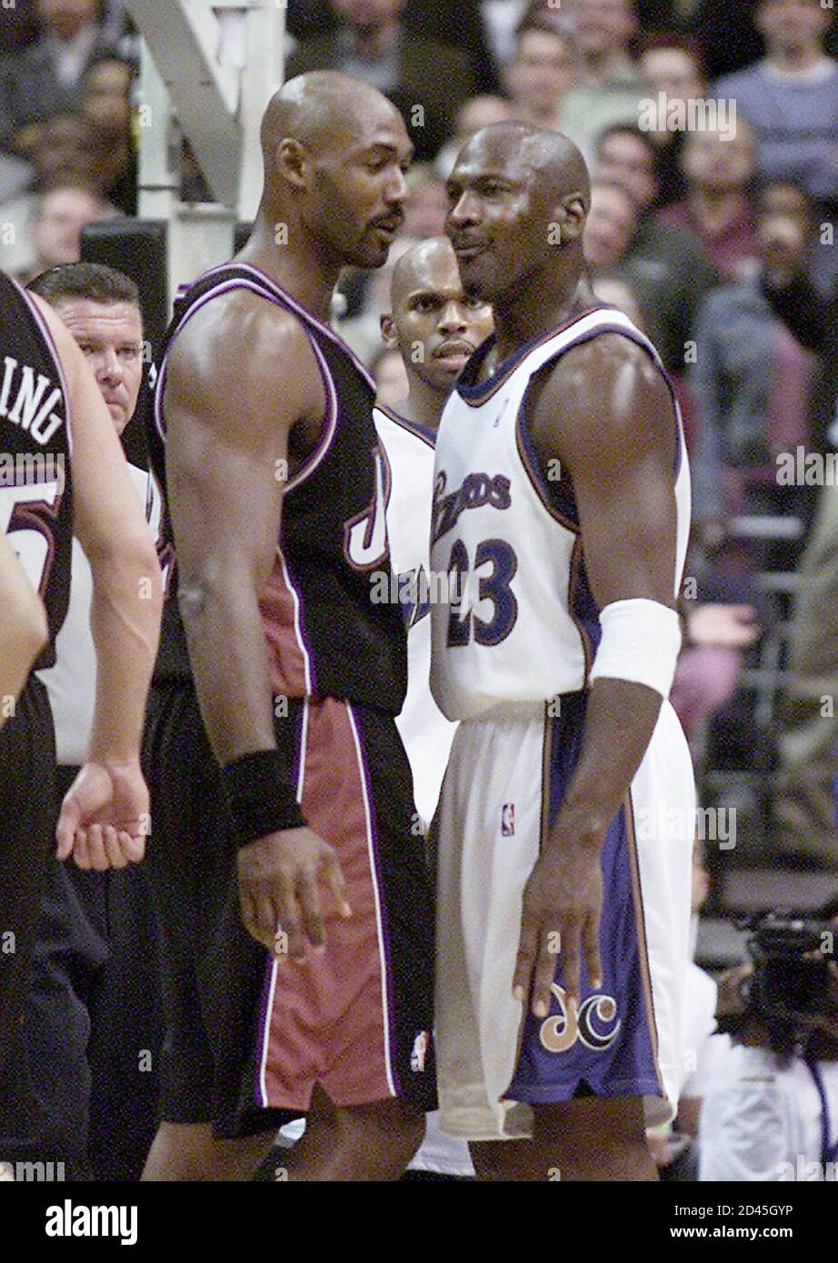 Washington Wizards' Michael Jordan (R) has words with Utah Jazz' Karl Malone  in the fourth quarter at the MCI Center in Washington November 14, 2002.  Both players received technicals by the referee.