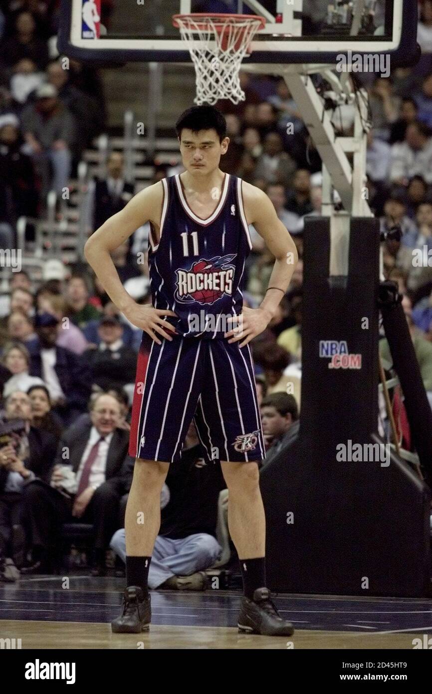 Houston Rockets center Yao Ming watches action during the Rockets NBA game  against the Washington Wizards in Washington, February 27, 2003.  REUTERS/Hyungwon Kang HK Stock Photo - Alamy