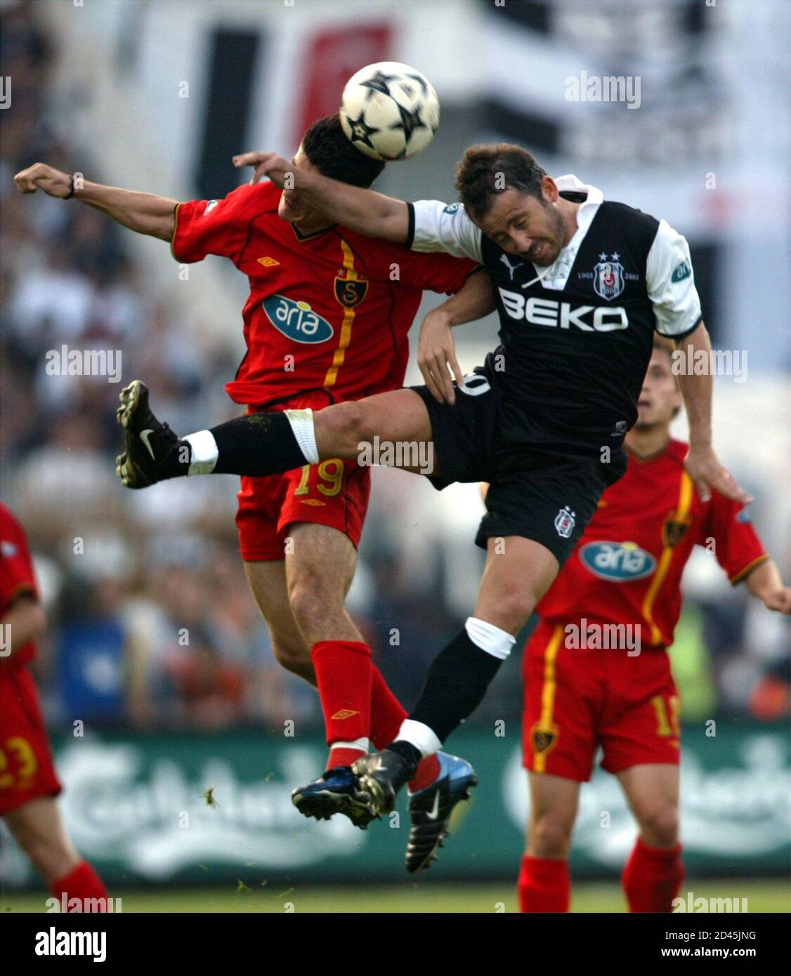 Besiktas midfielder Sergen Yalcin (R) and Galatasaray midfielder Cihan  Haspolatli (L) jump for a header in their Turkish Super League derby match  in Istanbul May 25, 2003. Besiktas clinched their first Turkish