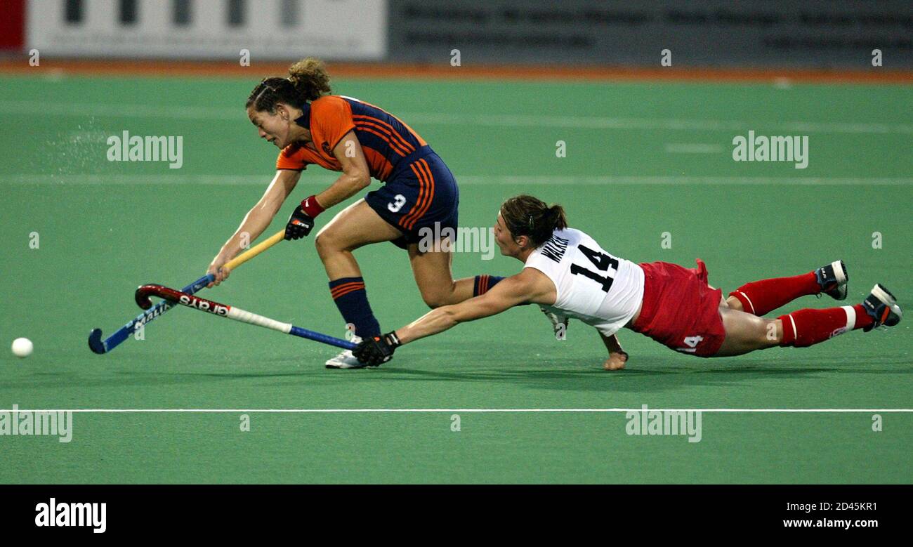 walker from england dives to tackle vaart from the netherlands the womens champions trophy hockey tournament in sydney rachel walker r from england dives to tackle macha van der vaart from the netherlands during their match at the womens champions trophy tournament in sydney december 4 2003 england defeated the netherlands 1 0 reutersdavid gray pp03120011 2D45KR1