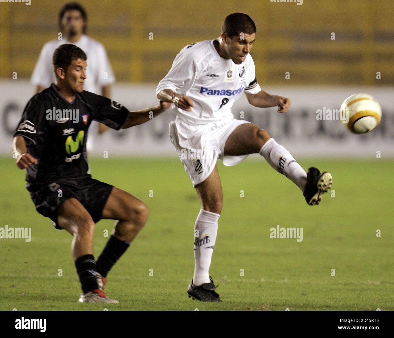 Ricardinho R Of Brazilian Team Santos Challenges For The Ball With Patricio Urittia Of Ecuadorean Team
