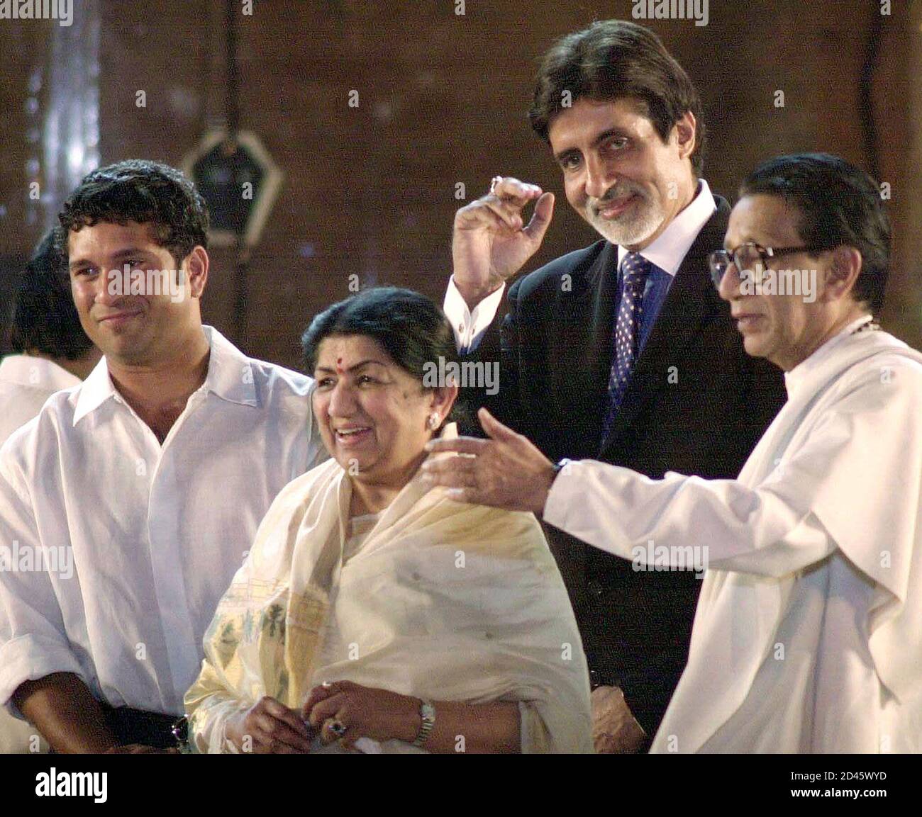 Indian celebrities (L to R) cricketer Sachin Tendulkar, singer Lata  Mangeshkar, Bollywood actor Amitabh Bachchan and leader of the militant  right-wing Shiv Sena Party Bal Thackeray appear during a concert in Bombay,