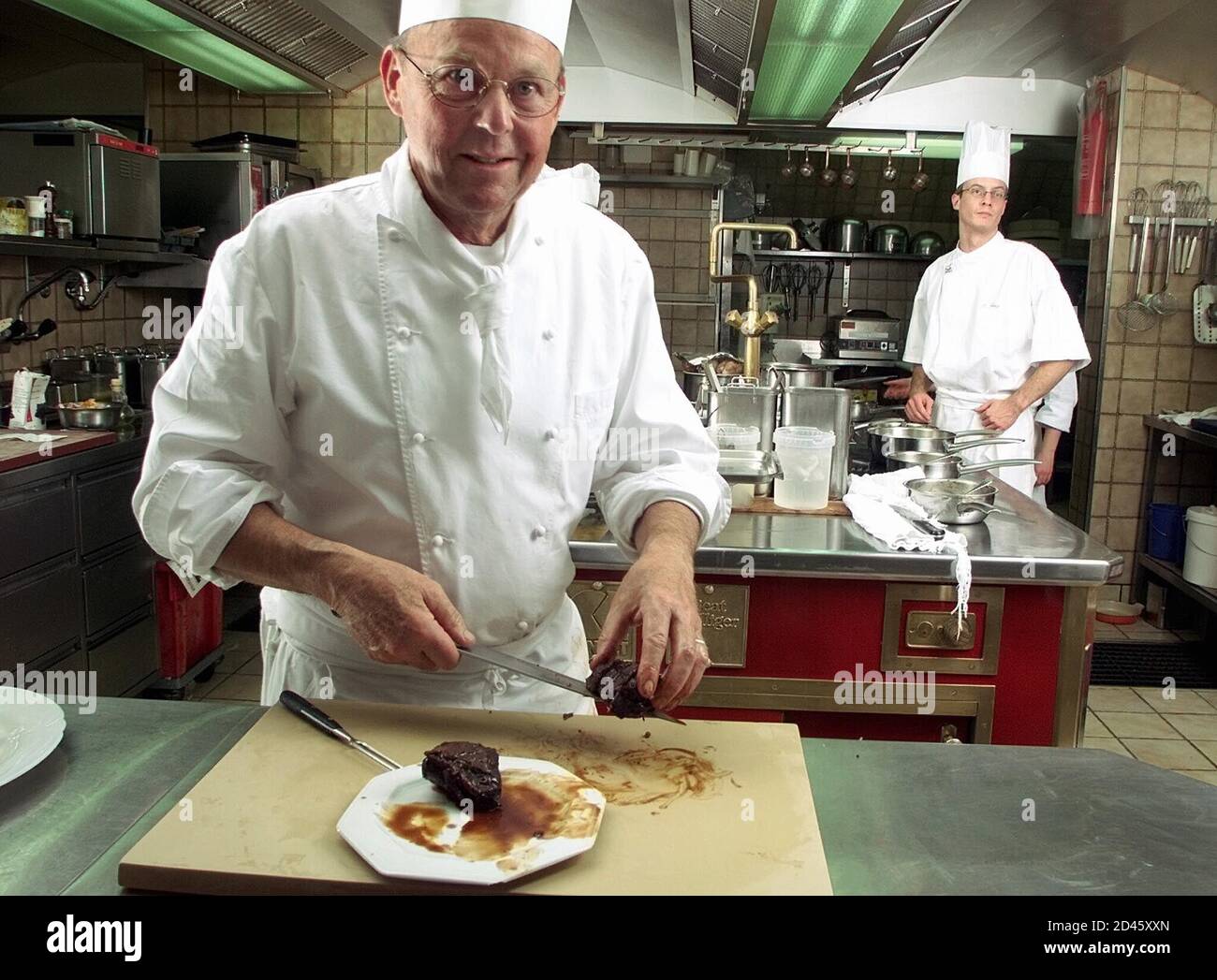 Swiss chef Beat Bolliger, of the gourmet restaurant at the Walserhof Hotel  in Klosters, Switzerland, prepares meat in this December 2000 file photo.  British Prince Charles' son Prince Harry plans to work