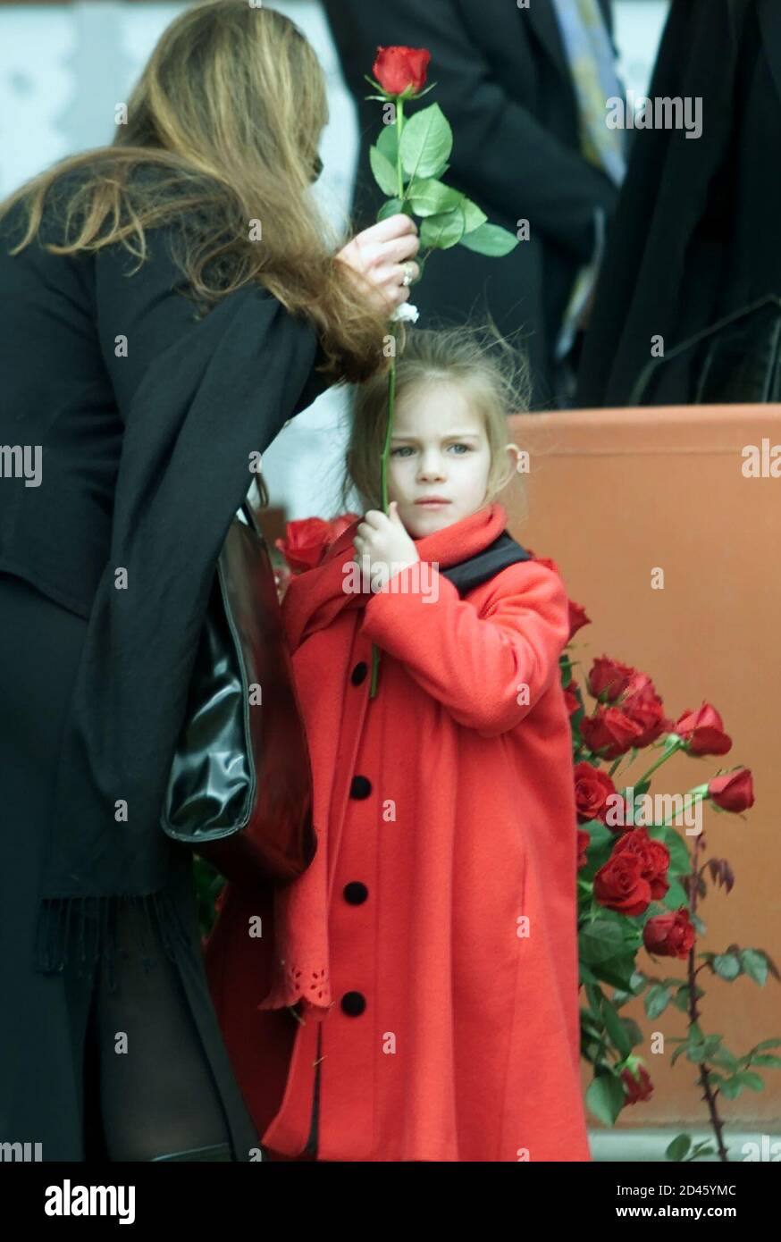 Lara Barnard, 4, youngest child of pioneering heart transplant specialist Dr Christiaan Barnard, holds a flower at her fathers funeral service, September 14, 2001. Dr Barnard, 78, who performed the world's first heart transplant in 1967, died September 2 in Cyprus. His ashes were interred in the garden of the house he was born in in the small farming town of Beaufort West. REUTERS/Mike Hutchings  MH/ Stock Photo