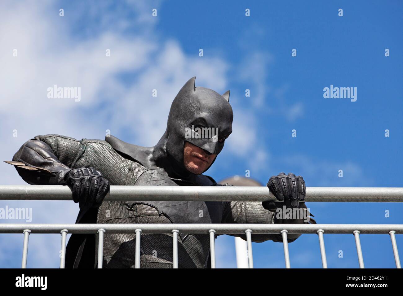Umea, Norrland Sweden - September 5, 2020: Batman stands by metal fence and looks down Stock Photo