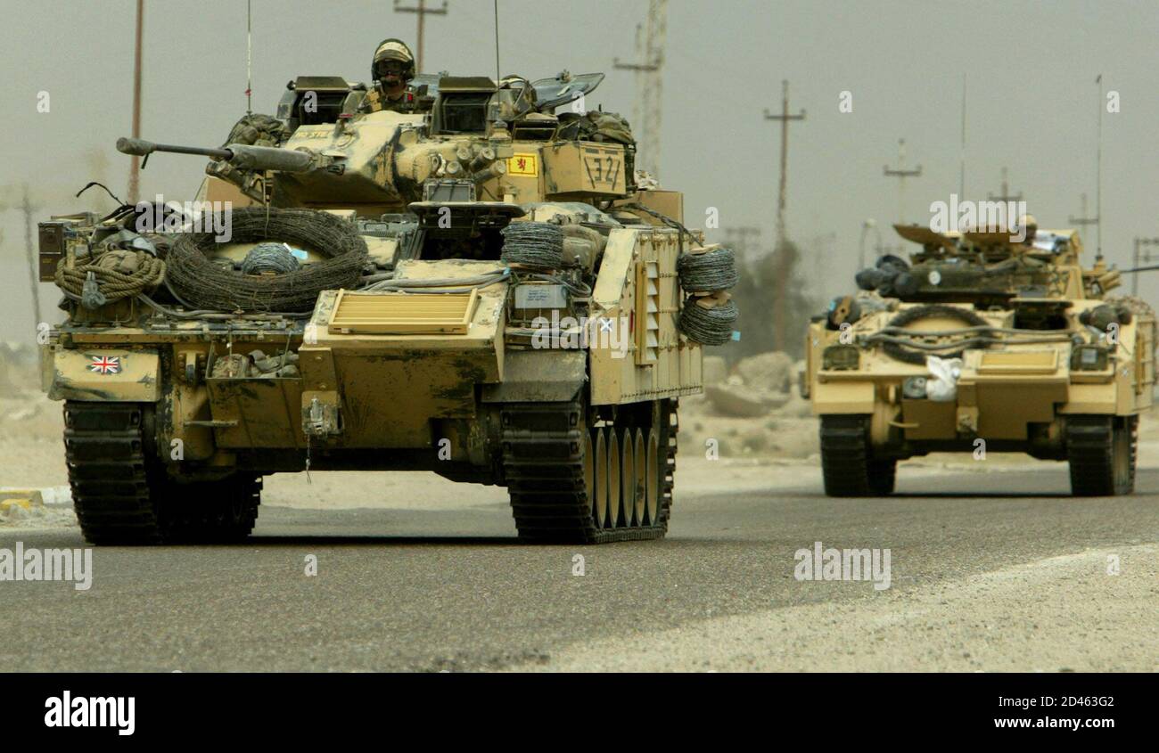 Tanks of the British 7th Armoured Brigade heading up the road towards to the southern Iraqi town of Basra March 22, 2003. The United States and Britain unleashed their first daylight air strikes on Baghdad on Saturday after pounding it with a fearsome night blitz. After the bombing rose to a new intensity in the Iraqi capital, U.S. forces said they had captured a vital crossing point over the Euphrates river, and were battling towards Iraq's second city of Basra in the south. REUTERS/Jerry Lampen  JFL/ Stock Photo