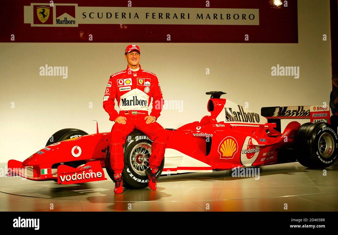 Ferrari's German driver Michael Schumacher is all smiles as he unveils the  F2004, Ferrari's new Formula One racing car at their factory in Maranello,  northern Italy January 26, 2004. REUTERS/Giampiero Sposito DJM/ACM