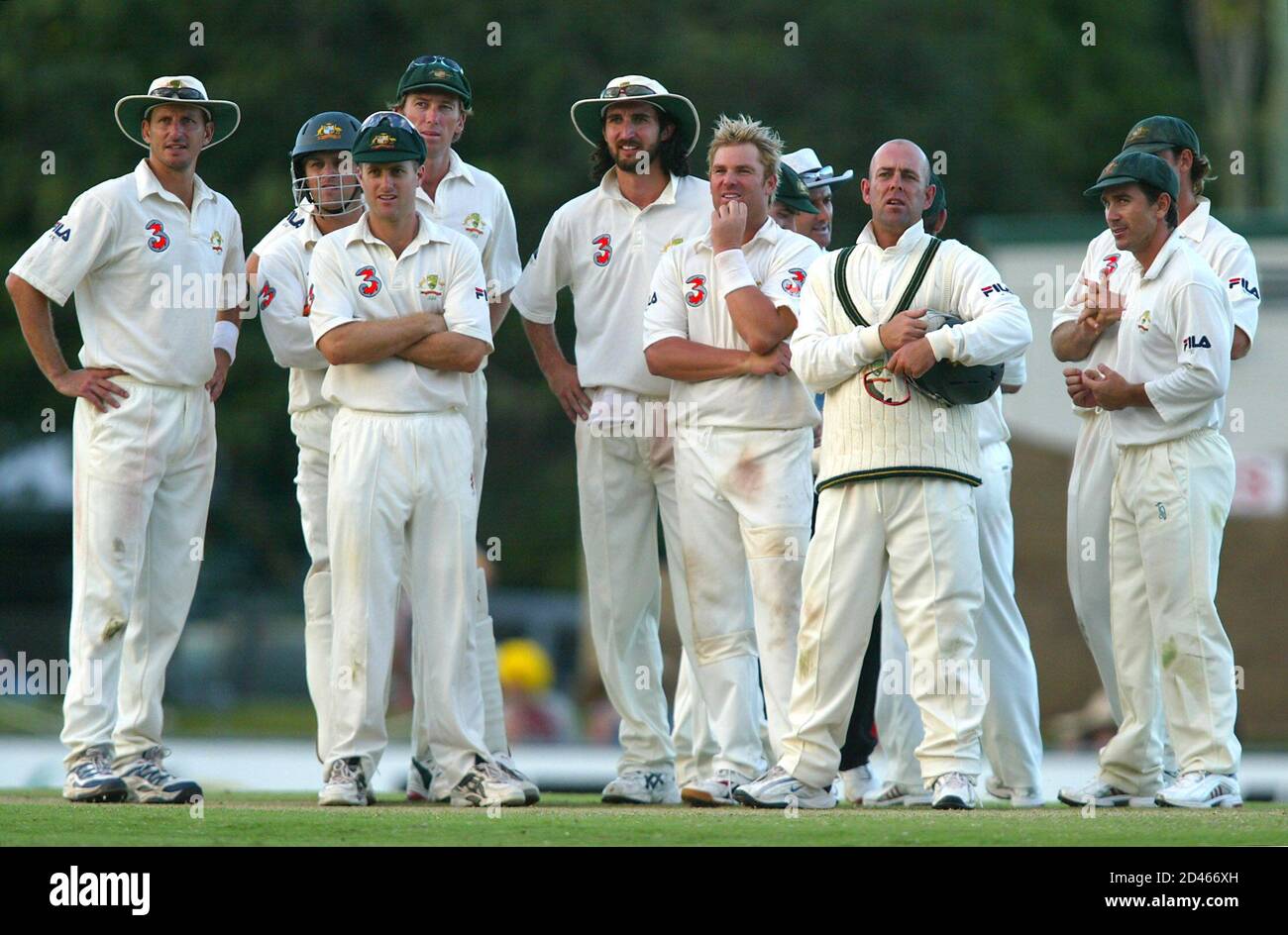 Australian team members look towards the third umpire's booth as they wait for a decision that allowed Shane Warne (6th-L) to equal the 527 test wicket-takers record, on the fifth day of the second test at Cazaly's Stadium in the northern Australian city of Cairns July 13, 2004. Australia won the off-season two test match series against Sri Lanka 1-0 after the second match in Cairns ended in a draw. REUTERS/Tim Wimborne  TBW/SH Stock Photo