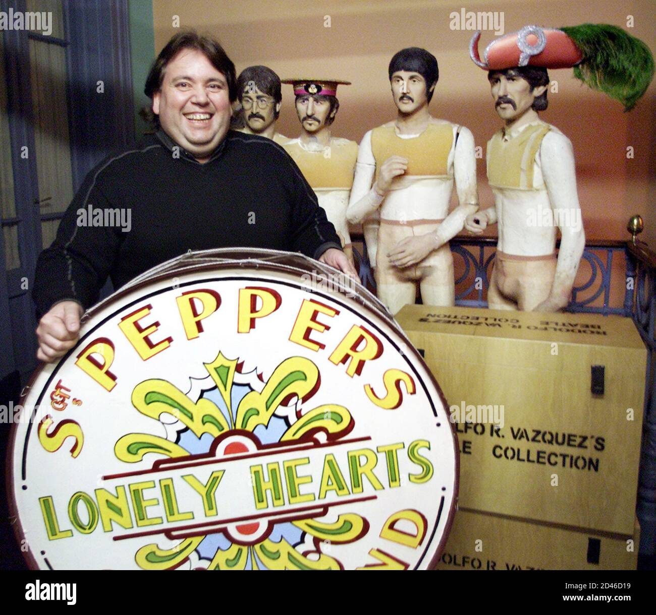 Argentine collector Rodolfo Vazquez holds a replica of the Sgt. Pepper's Lonely Hearts Club Band's bass drum in his Buenos Aires apartment where he houses most of the 5,612 items that comprise what Is recognized by the Guinness Book of World Records as the world's largest Beatles collection, October 1, 2001. The 44-year-old owner of 'The Cavern Club Buenos Aires' is about to turn another dream into reality - hosting the first ever Beatles Week festival outside Liverpool. PICTURE TAKEN OCTOBER 1. REUTERS/Rickey Rogers  RR Stock Photo