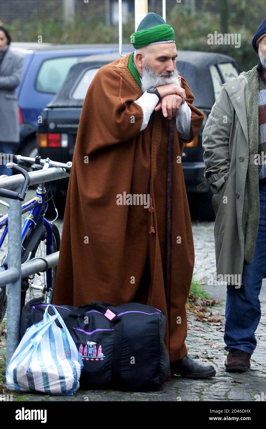 A Turkish inhabitant of THE western German town of Cologne rests beside his bags near an Islamic centre in Cologne December 12, 2001. Police closed the centre after Germany banned a network of radical Islamic groups around the Cologne-based organisation of Metin Kaplan, widely known in Germany as the 'Caliph of Cologne'. The leader of the group is serving a jail term for calling for the murder of rival religious leaders. REUTERS/Juergen Schwarz REUTERS  JS/WR Stock Photo