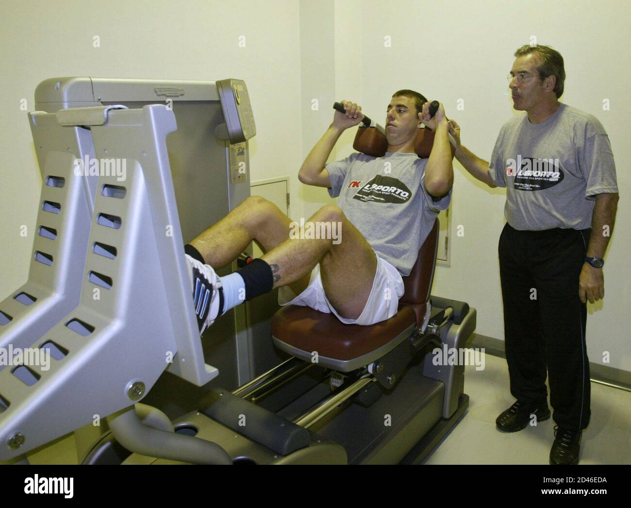 Uruguayan defender Alejandro Lembo works out under the supervision of Uruguayan physical trainer Esteban Gesto (R) at Toranomon Hospital's gym in Gotemba city, May 22, 2002. Uruguay is training in Japan in preparation for the World Cup soccer finals in which Uruguay will face France, Denmark and Senegal in Group A. REUTERS/Andres Stapff AS/PB Stock Photo