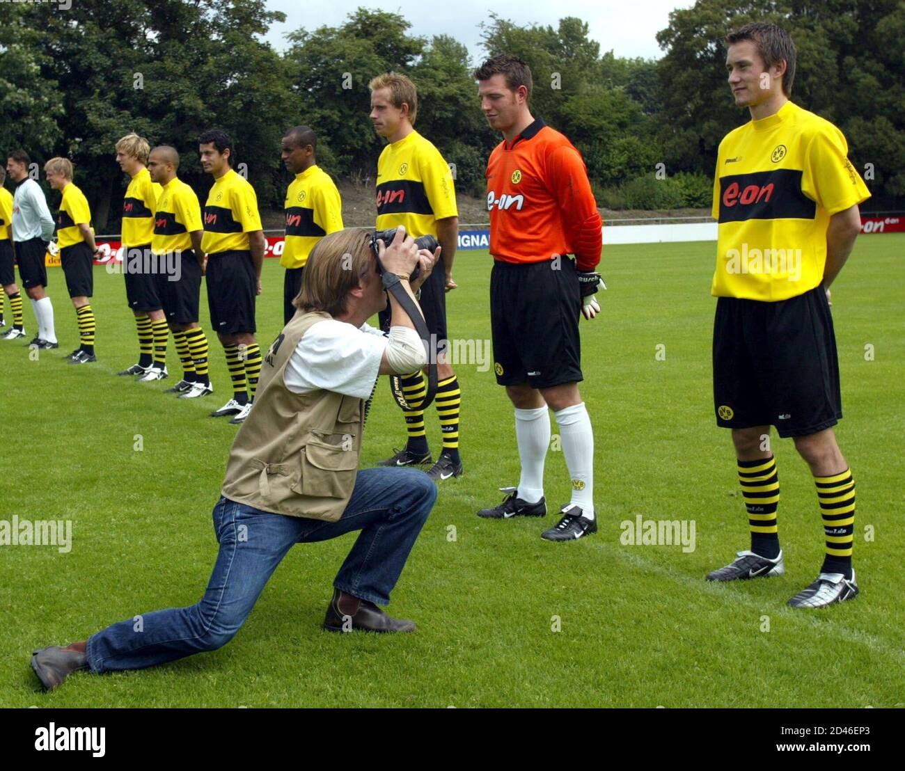 A photographer takes a photo of Borussia Dortmund's Tomas Rosicky (R) from the Czech Republic during the official team presentation in Dortmund July 5, 2002. Borussia Dortmund, which play in the German premier league Bundesliga won the German Championship in May 2002. REUTERS/Ina Fassbender REUTERS  INA/FAB Stock Photo