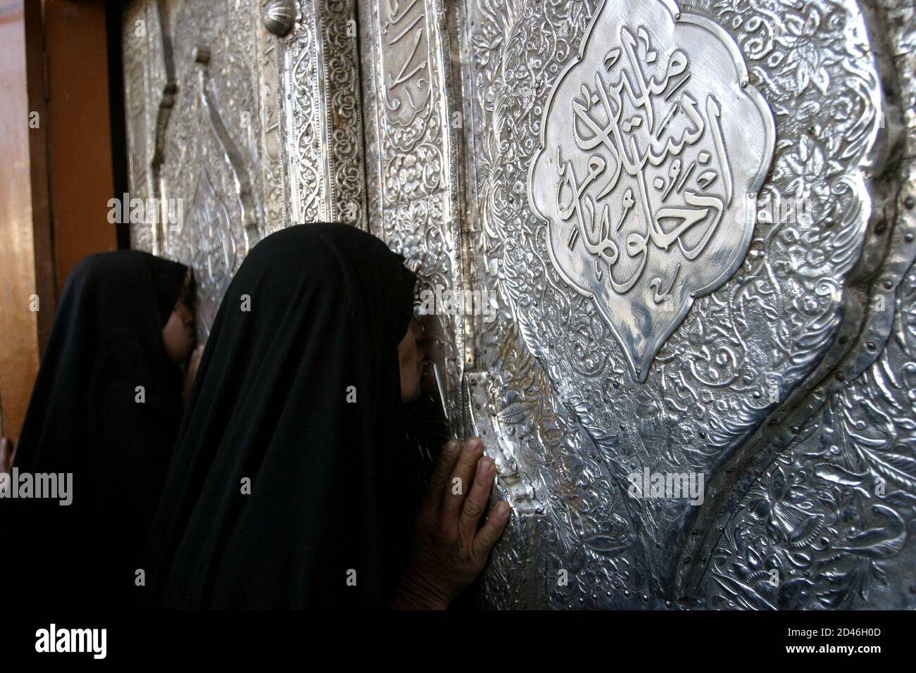 Iraqi Shi'ite women pray at the Imam Kadem al-Mansur mosque in  Baghdad, May 4, 2003. Life is slowly returning to normal in the capital as a majority of Iraqis are still waiting for an interim government to pave the way for a democracy after the toppling of [Saddam Hussein.] Stock Photo