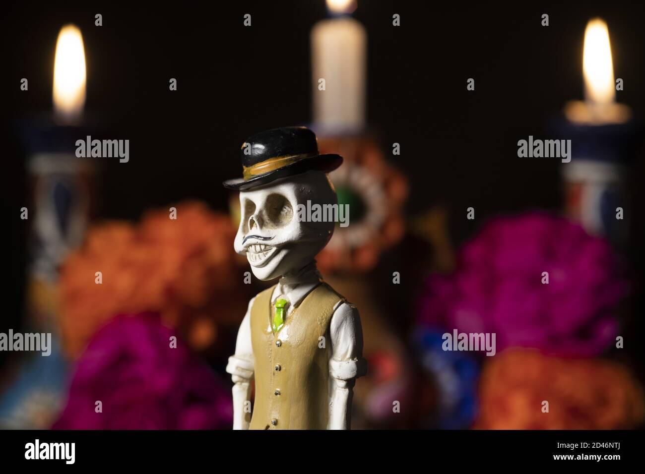 Closeup shot of plastic skulls figurine with a hat for an offering of the day of the dead Stock Photo