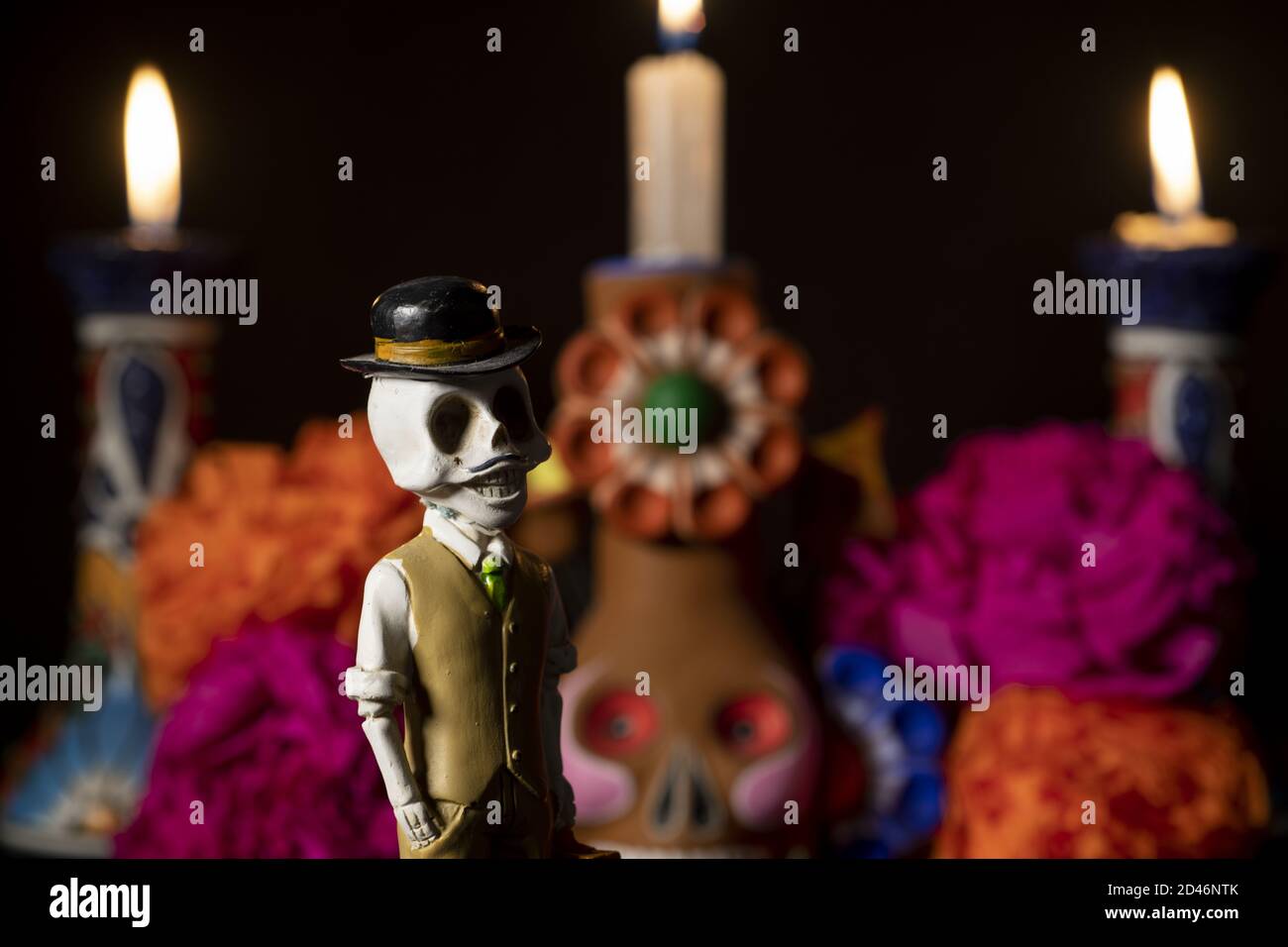 Closeup shot of plastic skulls figurine with a hat for an offering of the day of the dead Stock Photo