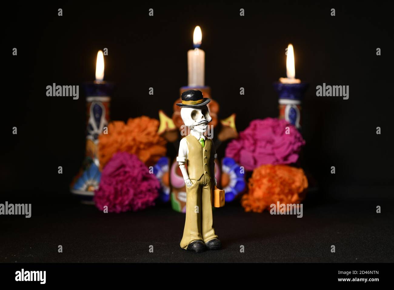 Closeup shot of plastic skulls figurine with a hat for an offering of the day of the dead Stock Photo