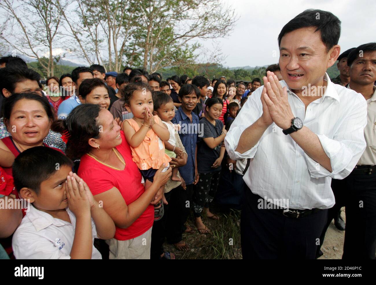 Thai Prime Minister Thaksin Shinawatra greets villagers in Yala province, 1,200 km (750 miles) south of Bangkok, on February 16, 2005. Thaksin arrived in the largely Muslim south on Wednesday with a stern message for villagers tempted to help separatist militants. REUTERS/Sukree Sukplang  SS/SA Stock Photo