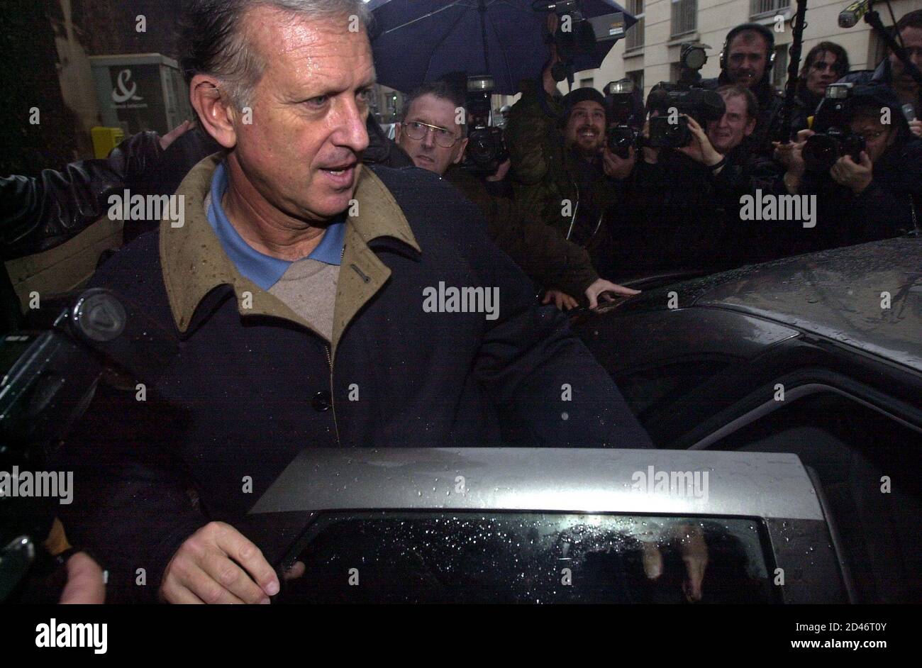 Former Cooperation Minister Michel Roussin enters  his car as he leaves Paris's Sante prison December 6, 2000. Roussin was incarcerated and released on bail in connection with alleged party financing scams at Paris city hall. Stock Photo