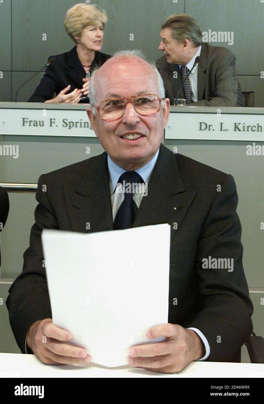 SUPERVISORY BOARD CHAIRMAN SERVATIUS IN FRONT OFGERMAN MEDIA MOGUL LEO KIRCH AND FRIEDE SPRINGER AT ANNUAL MEETING OF SPRINGER VERLAG AG IN BERLIN.   Chairman of the supervisory board Bernhard Servatius smiles as he sits in front of German media mogul Leo Kirch (R) and Friede Springer (L) before a annual shareholder meeting of the Springer Verlag AG publishing group in Berlin June 27, 2001. Kirch's company owns 40.5 percent of the German publishing empire. Stock Photo
