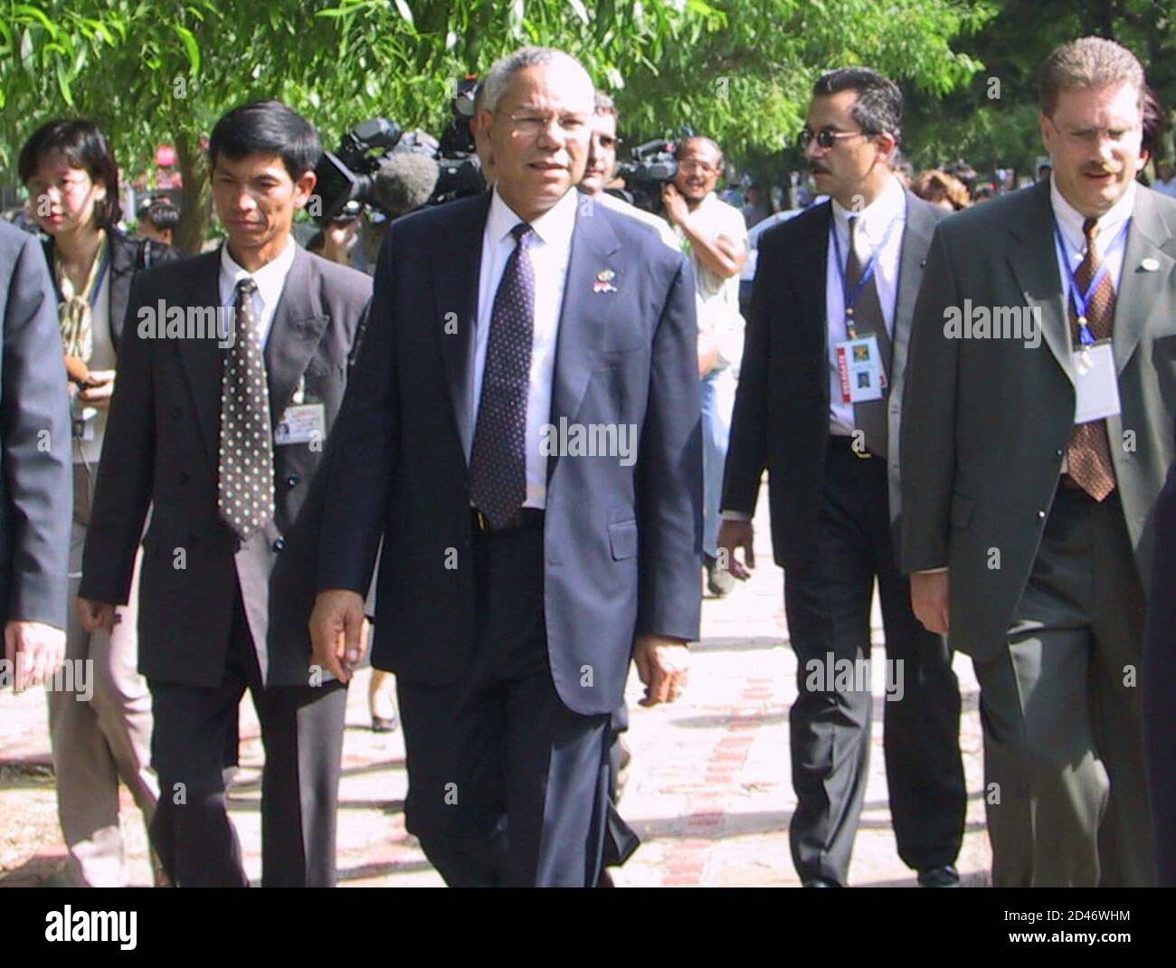 U.S. Secretary of State Colin Powell (C) walks down a Hanoi street, July 25, 2001 surrounded by secret service agents and Vietnamese security men. Powell, on his first visit in the country since his wartime service, surprised local people with an impromptu walkabout around a lake near his hotel. DB/DL Stock Photo