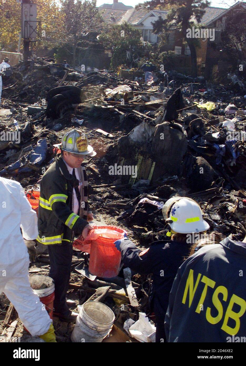 picture Crash Scene American Airlines Flight 587 Bodies https www alamy com a new york city firefighter hands another firefighter a container of human remains november 14 2001 from the crash site of american airlines flight 587 at the corner of beach 131st street and newport street in the rockaway beach section of queens new york reutersjim bourg jrbhk image381239210 html
