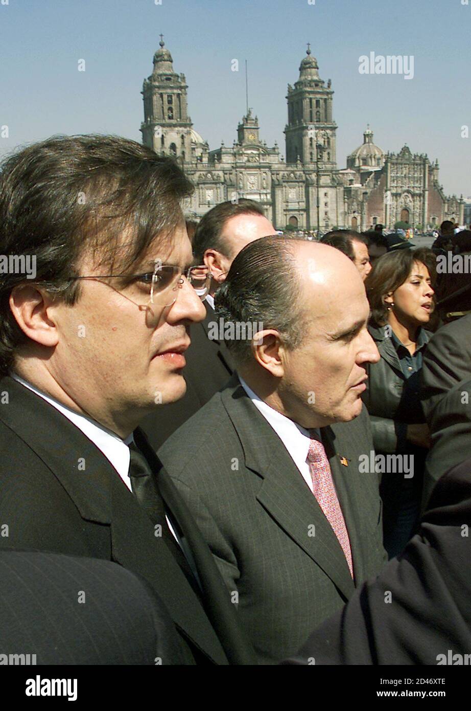 Former New York Mayor Rudy Giuliani (C) and Mexico City's police chief Marcelo Ebrad (L) walk during a tour in the Main Square of Mexico City on January 15, 2002. Famed for taming the streets of New York in the 1990's with his 'zero tolerance' crime policy, Giuliani has been hired for $4.3 million by a group of prominent Mexican businessmen to reduce Mexico City's soaring crime rate. REUTERS/Daniel Aguilar  DA Stock Photo