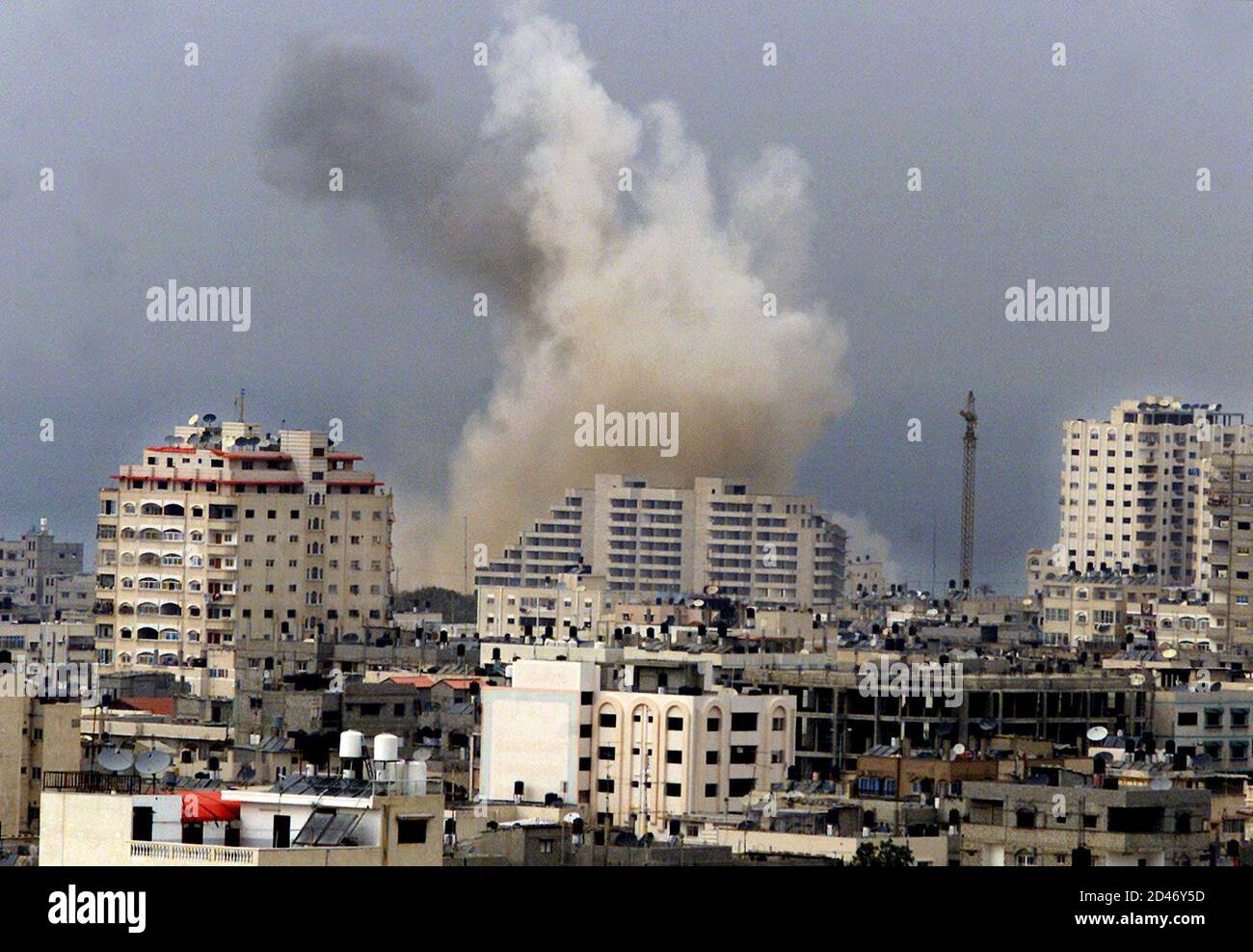 Smoke rises over Gaza after an Israeli warplane attacked the Palestinian police headquarters in the Gaza Strip March 10, 2002. [Israel retaliated on Sunday for a Palestinian suicide bombing that killed 11 Israelis in a Jerusalem cafe by destroying the Gaza headquarters that Yasser Arafat used as a showcase for Palestinian sovereignty.] Stock Photo