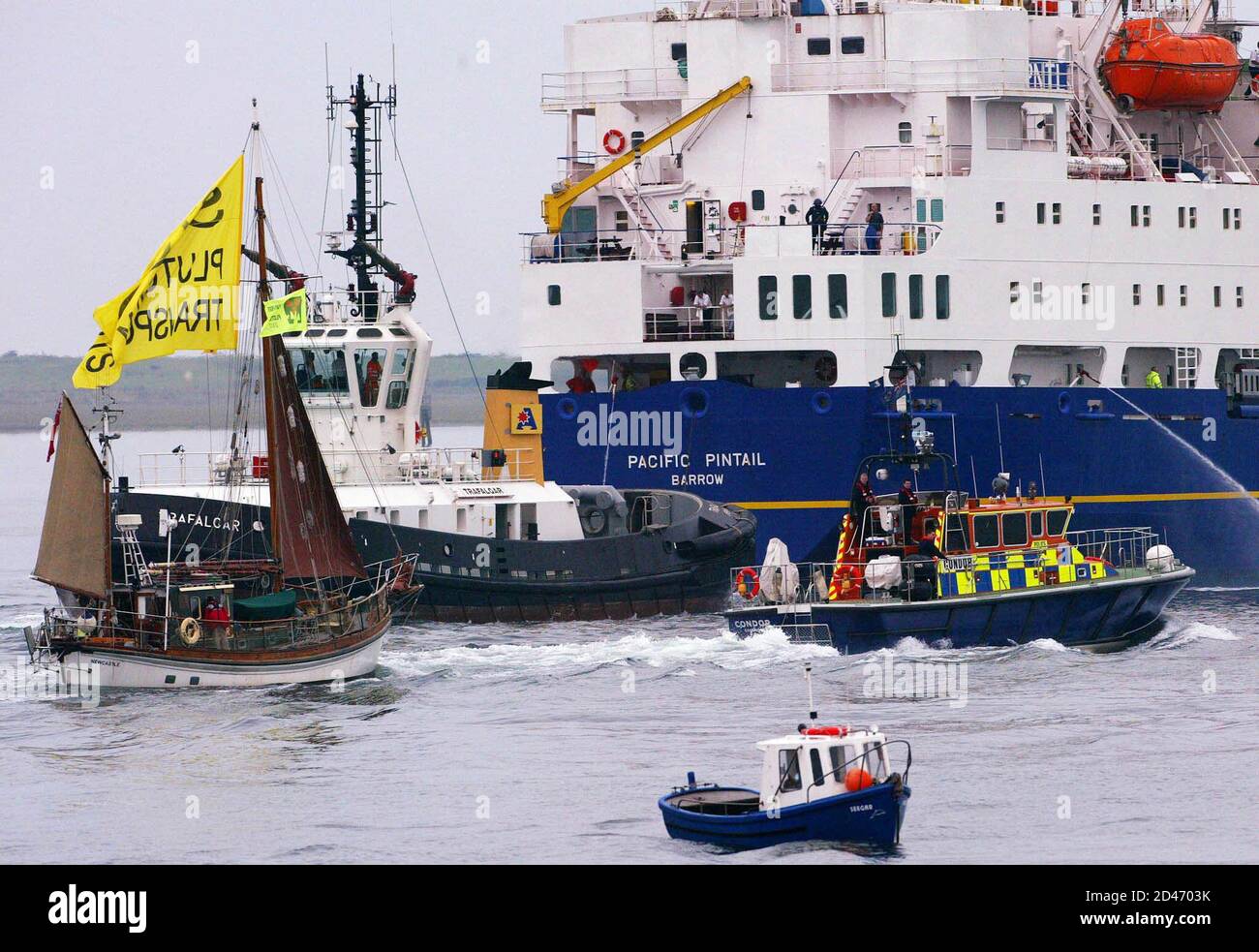 Anti-nuclear protestors and police escort the British Nuclear Fuels (BNFL) ship Pacific Pintail down the Walney channel to Barrow-In-Furness, September 17, 2002. A flotilla of boats led by the flagship Rainbow Warrior of the environmental group Greenpeace circled Pacific [Teal] and her sister ship Pacific Pintail, both carrying shipments of nuclear waste, as they neared their after a controversial two-month journey from [Japan]. [Environmentalists and national governments from New Zealand to Ireland feared the cargo of potentially weapons-usable MOX - mixed uranium and plutonium oxide fuel - c Stock Photo