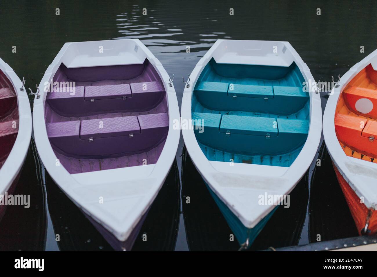 Boats tied to the wooden dock by the lake Stock Photo - Alamy
