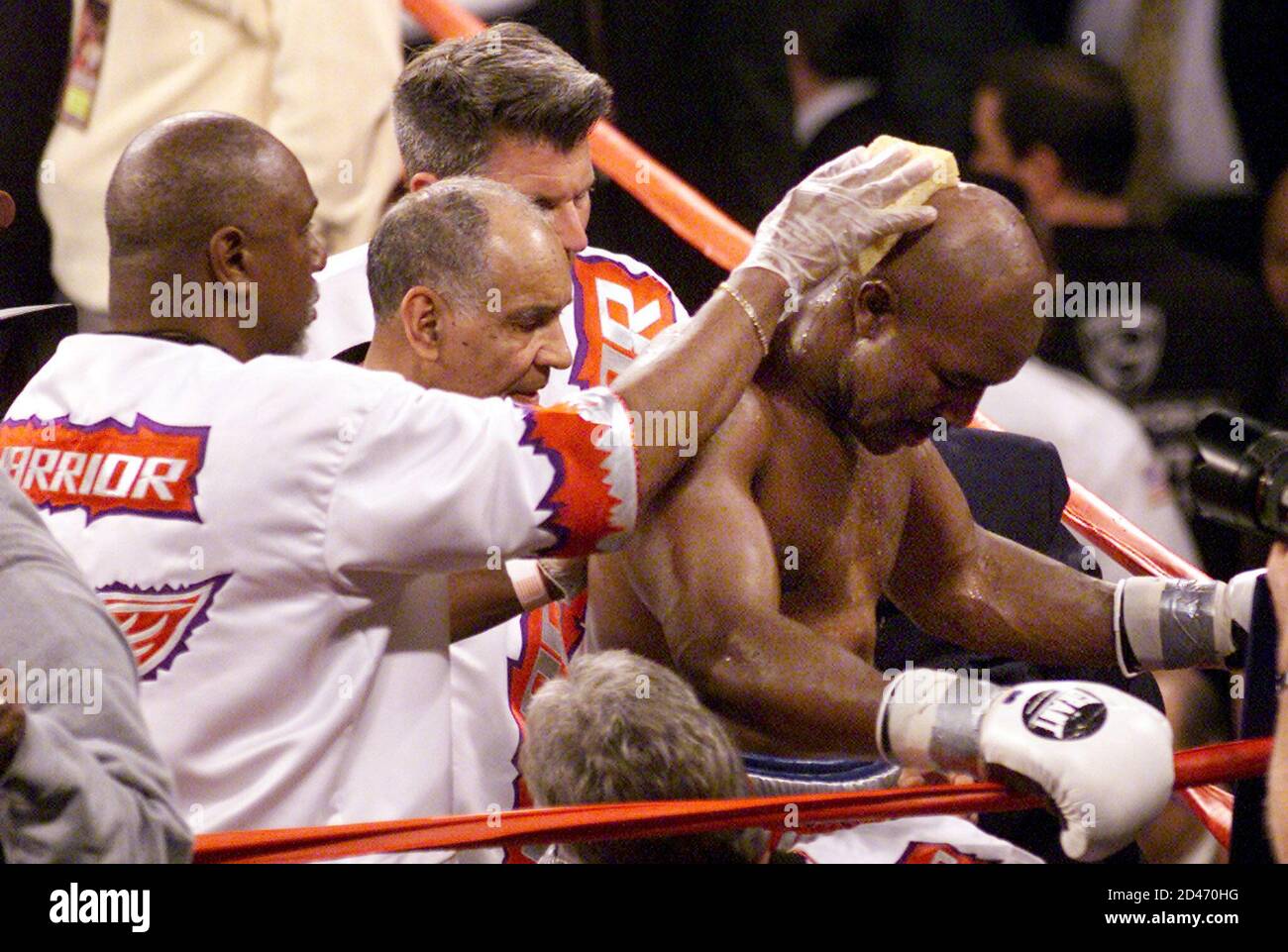 Former four-time heavyweight champion Evander Holyfield bows his head in his corner after the 12th round of his IBF heavyweight championship fight Chris Byrd at Hall in Atlantic City,