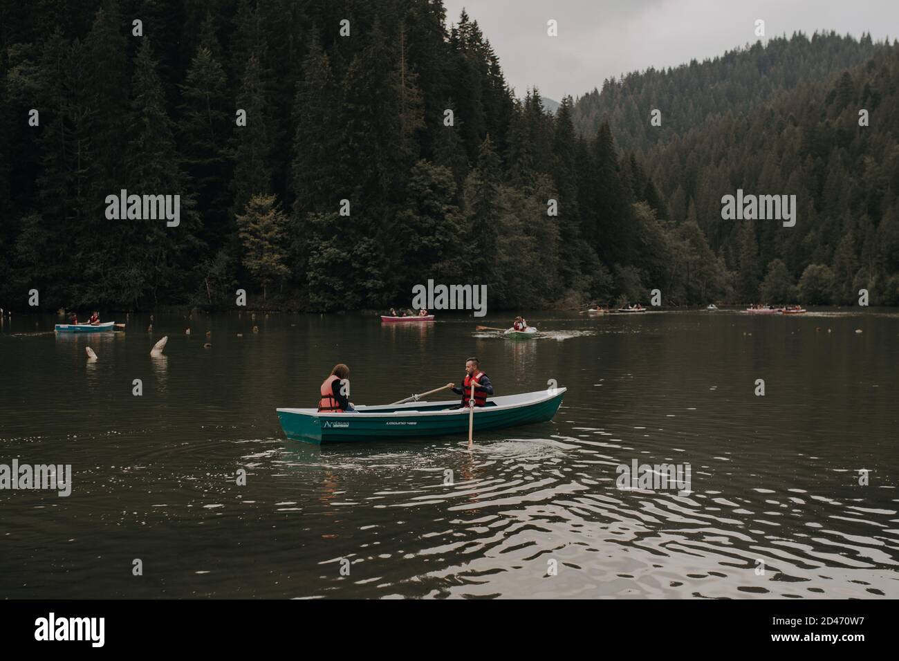 Boats tied to the wooden dock by the lake Stock Photo - Alamy