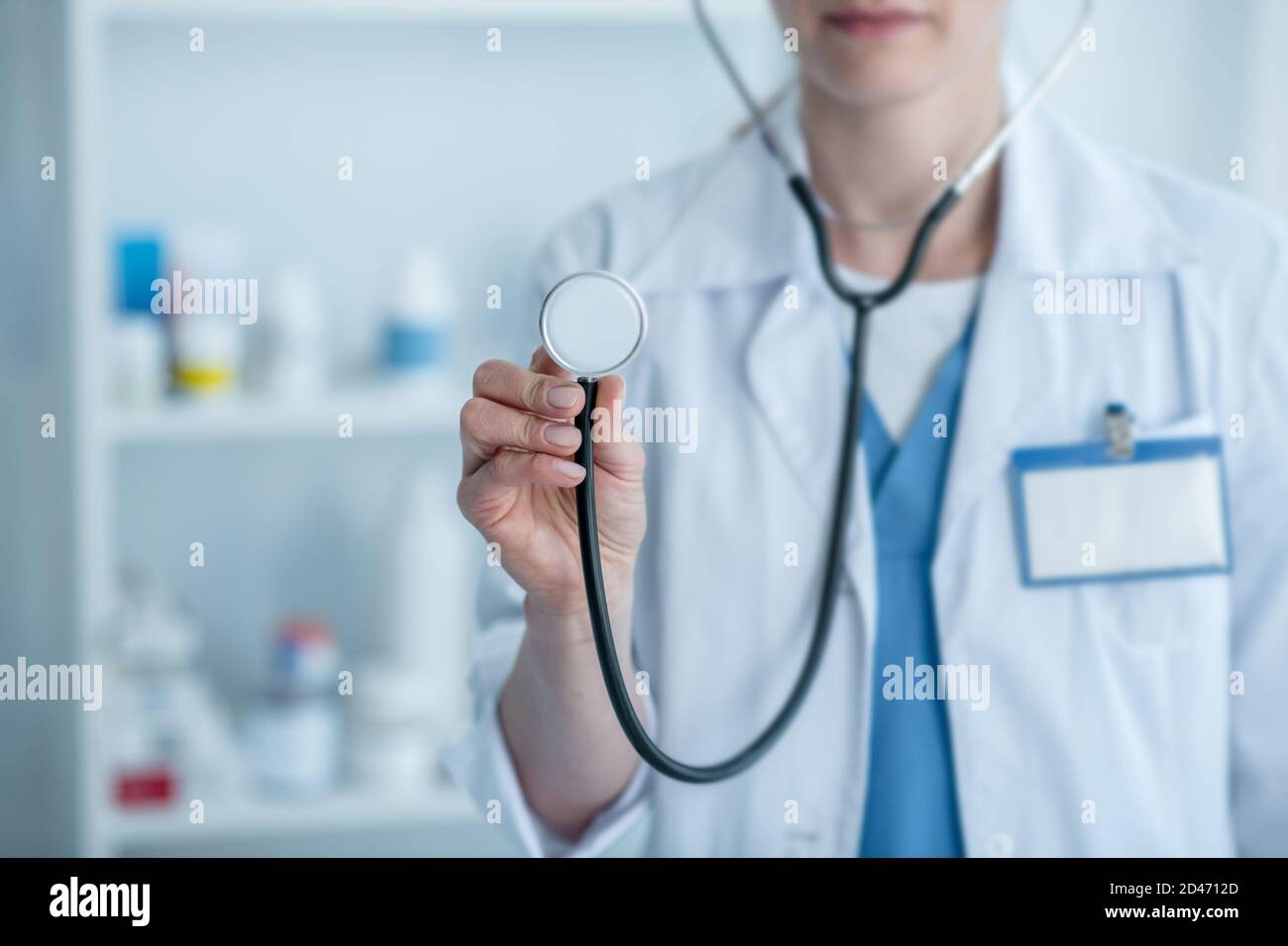 Doctor in a white lab coat holding a stethoscope Stock Photo Alamy
