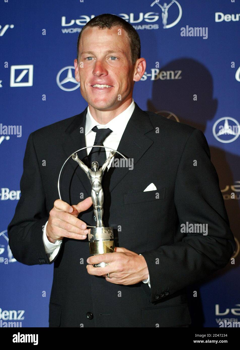 Lance Armstrong of USA holds his Laureus world sportsman of the year award after a ceremony in Monte Carlo, May 20, 2003. Armstrong and compatriot Serena Williams were named the sportsman and sportswoman of the year at the Laureus World Sports Awards on Tuesday. Armstrong, a cancer survivor who will chase a fifth  consecutive Tour de France victory in July, beat two-time winner Tiger Woods, last yearAEs winner Michael Schumacher, Brazilian soccer player Ronaldo and NorwayAEs record-breaking biathlete Ole Einar Bjoerndalen. REUTERS/Pascal Deschamps PP05040148 Stock Photo