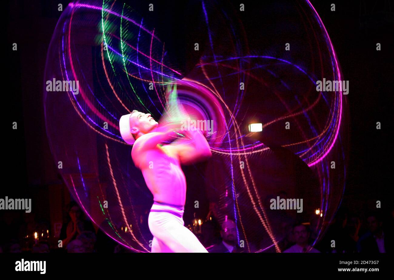 Hula Hoop artist Tigris performs during the premier of 'Liaison of senses' in the Chamaeleon Variete in Berlin.  Hula Hoop artist Tigris performs during the premier of 'Liaison of senses' (Liaison der Sinne) in the renovated Chamaeleon Variete in the German capital Berlin late February 24, 2004. REUTERS/Joachim Herrmann Stock Photo