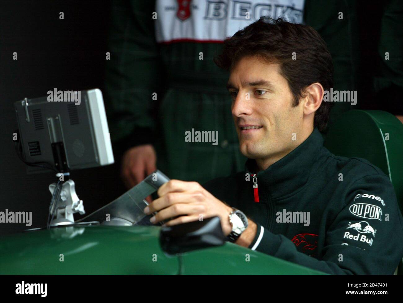 AUSTRALIAN FORMULA ONE DRIVER MARK WEBBER RACES IN A SIMULATOR DURING A VISIT TO SABANCI UNIVERSITY IN ISTANBUL.  Australian Formula One driver Mark Webber sits in a simulator to race with university students during a visit to Sabanci University in Istanbul April 28, 2004. Webber was in Turkey to promote F1 races expected to be held in the city next year. REUTERS/Fatih Saribas Stock Photo